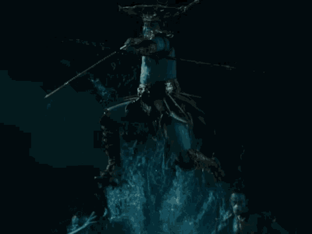 a statue of a man with a hammer on his head is surrounded by water
