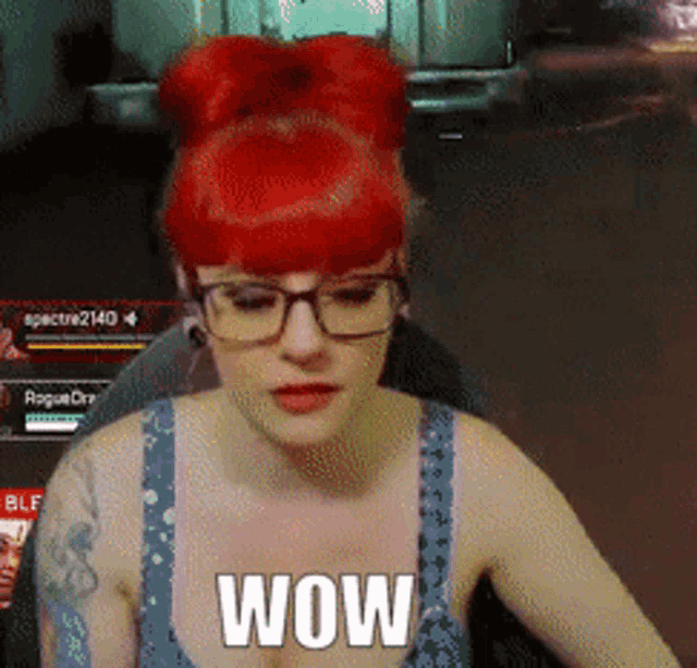 a woman with red hair and glasses says wow in a video game