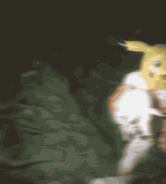 a blurry picture of a person wearing a yellow mask