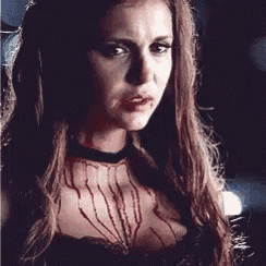 a close up of a woman with blood on her chest .