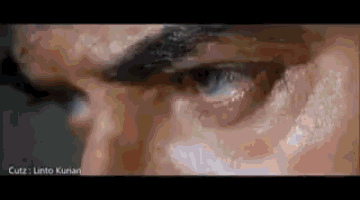 a close up of a man 's face with a blurred background and a blurry picture of his eyes .