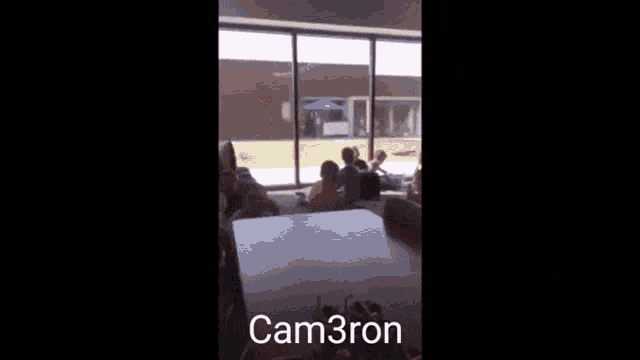 a blurry picture of a group of people with the name cam3ron written on the bottom