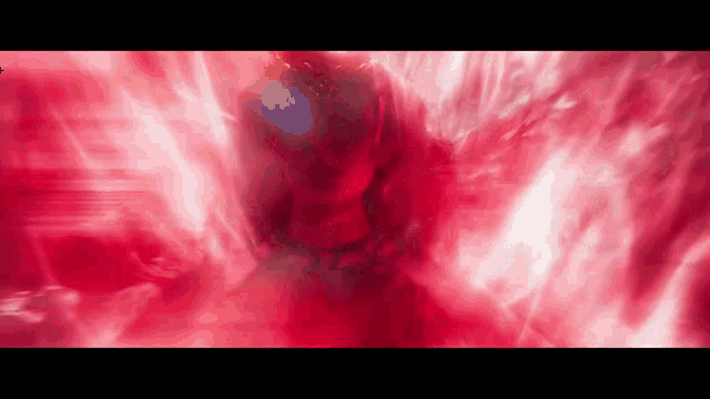a person is surrounded by red flames in a dark room .