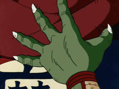 a green hand is reaching out towards a red object with the letter t on it