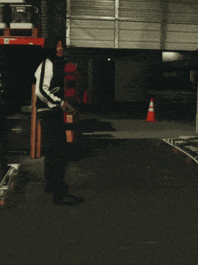 a man in a red shirt and a black and white jacket is dancing