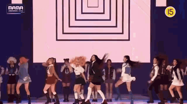 a group of girls are dancing on a stage at awards .