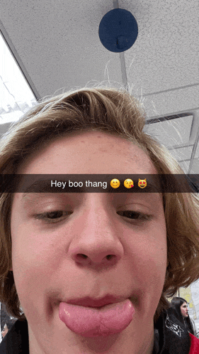 a young man sticking his tongue out with the caption hey boo thang on his face