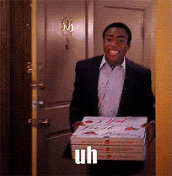 a man in a suit is holding a stack of pizza boxes with the word uh written on it