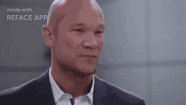 a bald man in a suit and white shirt is made with the reface app .