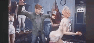 a man is standing next to a woman in a room holding a bottle of alcohol .