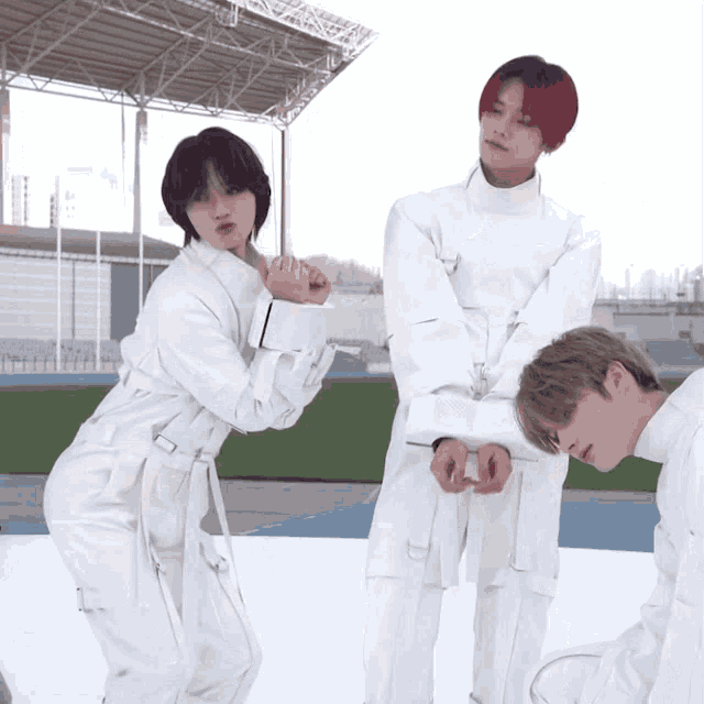 a group of people in white jumpsuits are posing for a photo