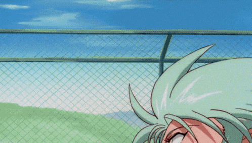 a girl with green hair is standing in front of a fence