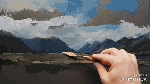 a person is painting a landscape with the words made in animotica below