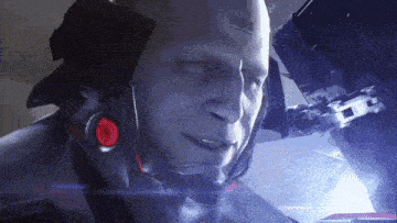 a close up of a robot 's face with a red eye
