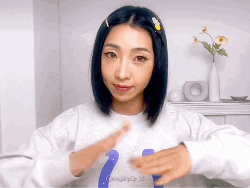 a woman wearing a white sweater with the number 21 on it