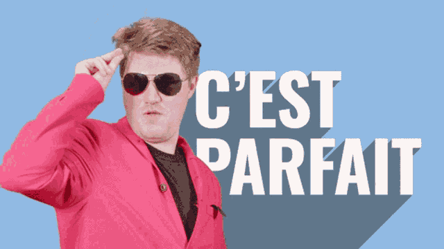 a man wearing sunglasses and a pink jacket stands in front of a sign that says c'est parfait