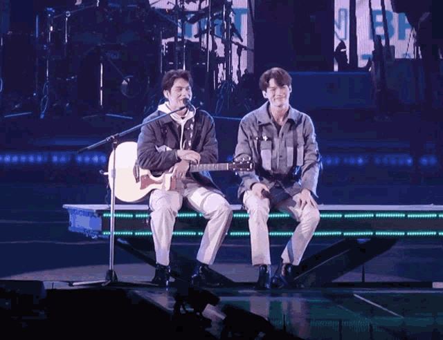 two men singing and playing guitar on a stage with the words still tonight written on the bottom