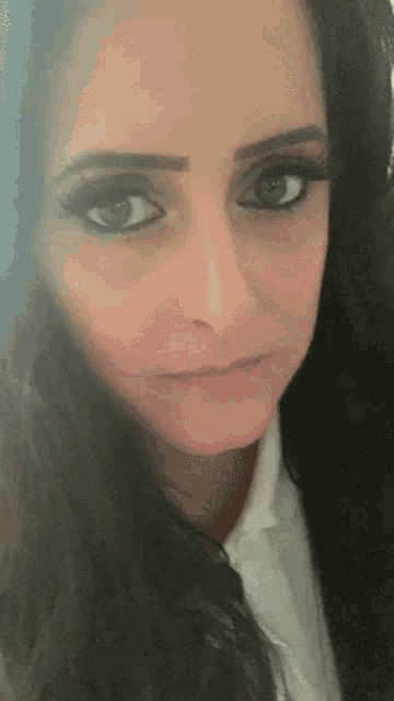 a close up of a woman 's face with long black hair