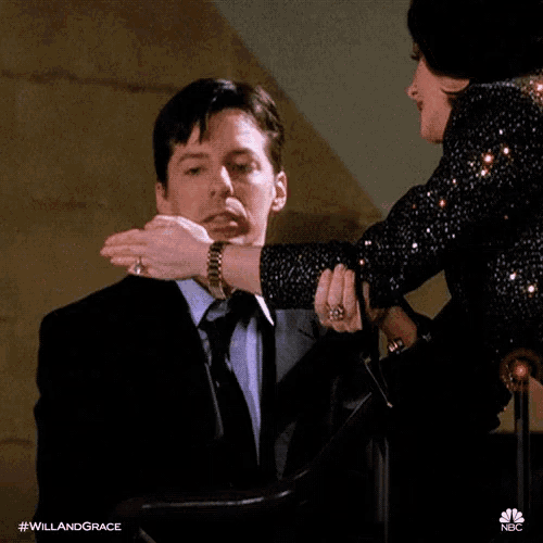 a woman is kissing a man on the cheek while he is wearing a watch .