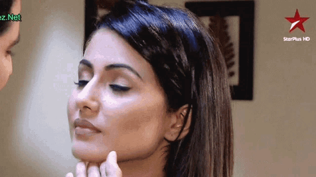 a close up of a woman 's face with a star plus hd logo behind her