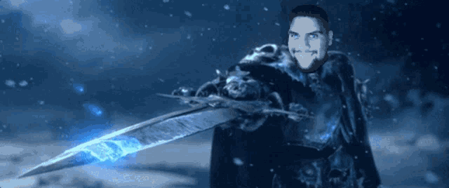 a man with blue eyes is holding a large sword in his hand