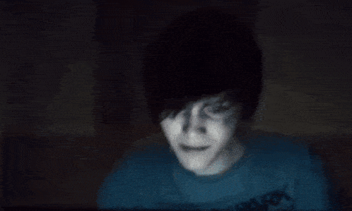 a blurry picture of a person laying down in a dark room