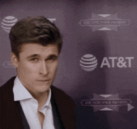 a man standing in front of an at & t logo