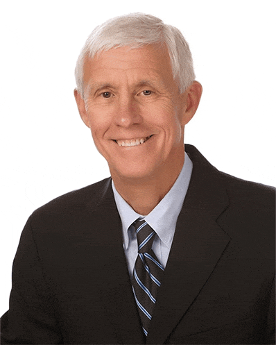 a man in a suit and tie smiles at the camera
