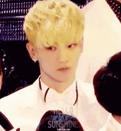 a man in a white suit and bow tie says hello sunshine