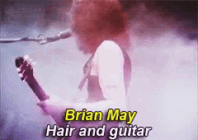 a man with red hair is playing a guitar and singing into a microphone