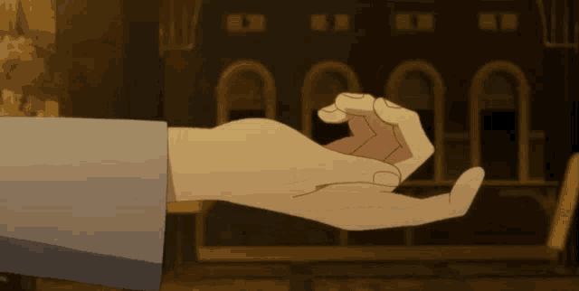 a person 's hand is shown making a peace sign