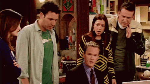 a group of people are gathered around a man in a suit