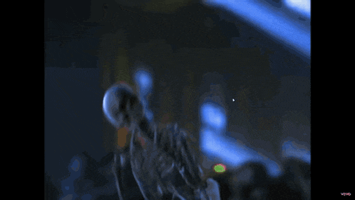 a skeleton is standing on a stage in a blue light ..