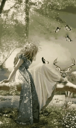 a woman in a blue dress is sitting on a tree branch next to a deer and butterflies .