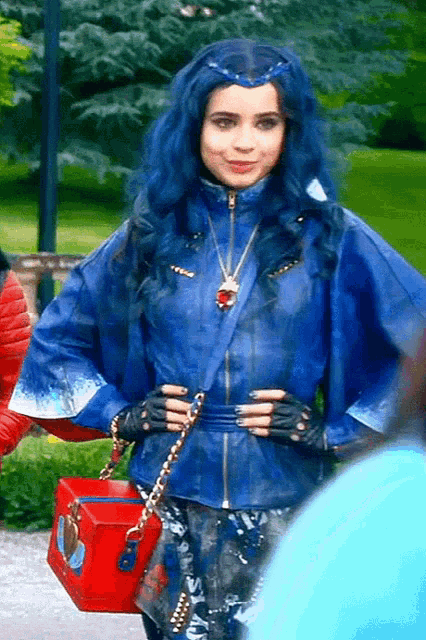 a woman with blue hair and a blue jacket is holding a red box