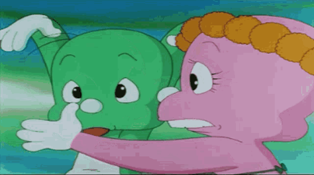 a green cartoon character and a pink cartoon character are hugging