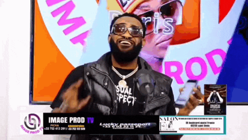 a man with a beard wearing sunglasses and a vest that says image prod