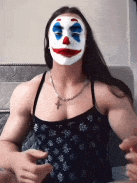 a woman wearing a clown mask with blue eyes