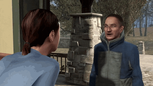 a man in a blue jacket talking to a woman