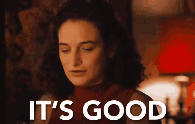 a woman in a red sweater with her eyes closed says it 's good