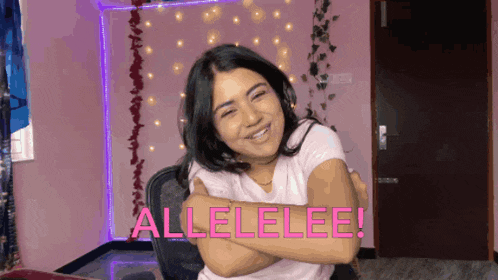 a woman is hugging herself in a room with the words allelelee written in pink