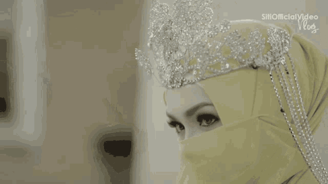 a close up of a woman wearing a veil with the words siri official video on the bottom right