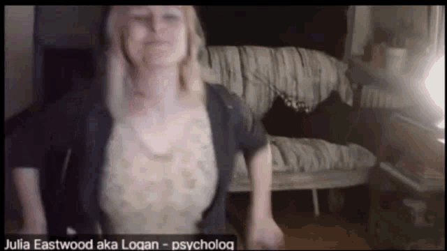 a woman named julia eastwood aka logan is standing in front of a bed