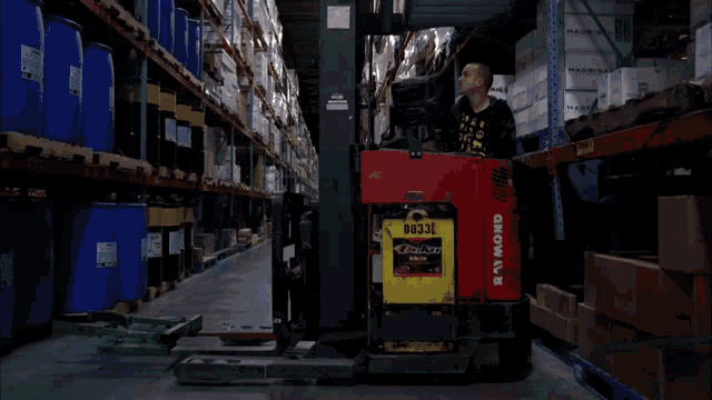 a forklift in a warehouse has the number 66 on the side of it