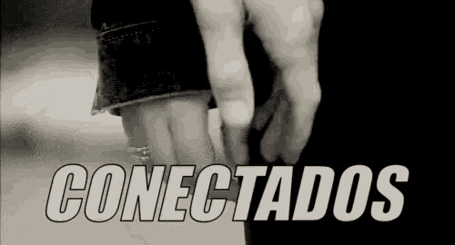 a man and a woman are holding hands in a black and white photo with the words conectados written above them .