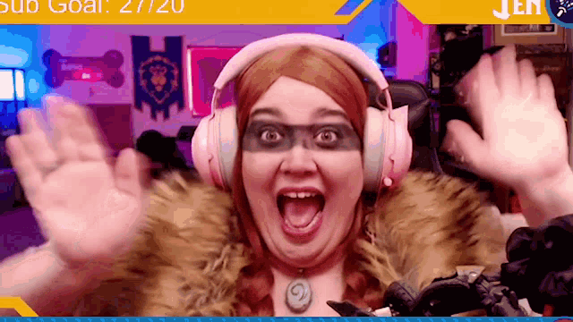 a woman wearing headphones and a fur coat has her mouth open and her hands up