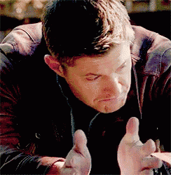 a man in a leather jacket is making a funny face with his hands .
