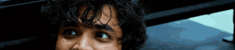 a close up of a man 's face with a tear coming out of his eye