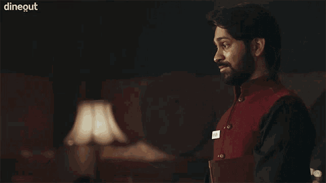a man in a red vest has a name tag that says " gaur "