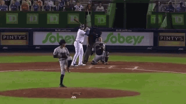 a baseball player with the number 33 on his jersey is running towards the base